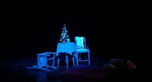 theatre stage set with overturned chair indicating abusive relationship
